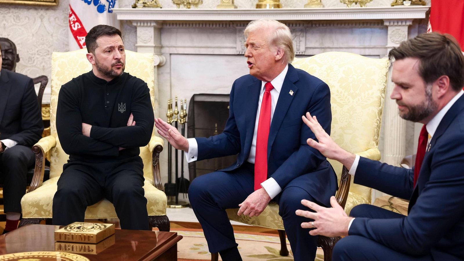 A press conference in the White House in Washington. On the left, sitting with crossed arms is Ukrainian President Volodymyr Zelenskyy, while President Donald Trump and Vice President J. D. Vance gesture with raised hands on his right. A press conference in the White House in Washington. On the left, sitting with crossed arms is Ukrainian President Volodymyr Zelenskyy, while President Donald Trump and Vice President J. D. Vance gesture with raised hands on his right.